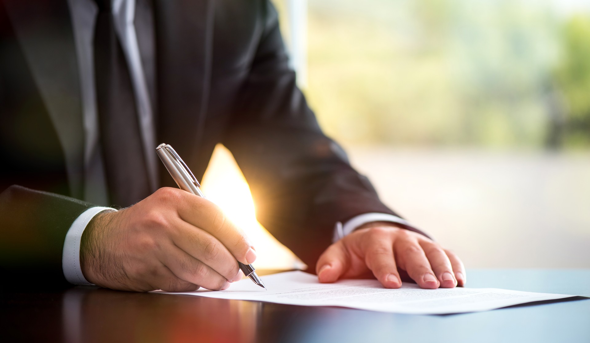 Businessman Is Signing A Legal Document In Office